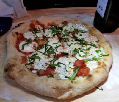 Neapolitan style pizza on the grill, Margherita pizza with tomatoes, fresh mozzarella, and basil
