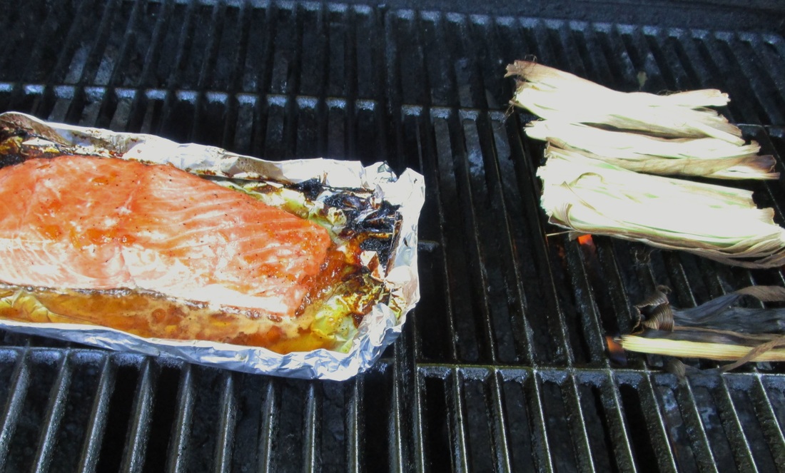 Smoke corn husks on the grill to infuse flavor in the salmon