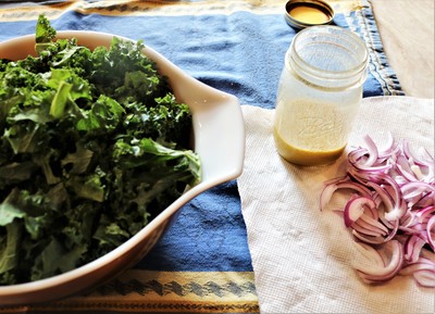 Winter Salad with Kale and Pomegranate - Dress the greens and onions in advance